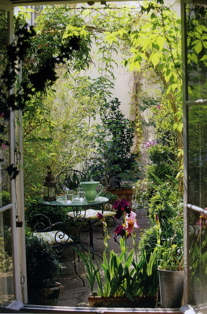 romantic urban garden with tea table